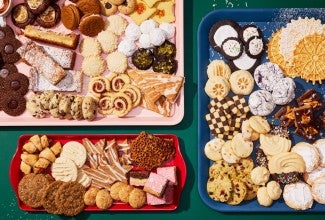 Three platters with many different varieties of cookies