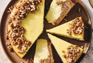 Carrot Cake Cheesecake with golden creamy cheesecake and edged with walnuts.