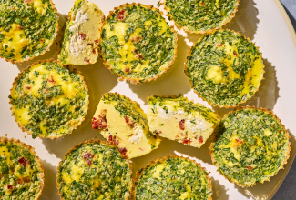 Egg Bites seen from the top showing greens and a cross-section of one with quiche like interior and cottage cheese within.