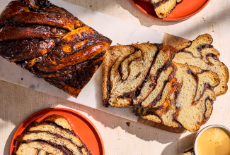 Chocolate Sourdough Babka sliced and arranged with other elements on a counter and seen from above.