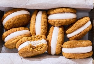 Oatmeal Cream Pies in a basket showing one with a bite taken out.
