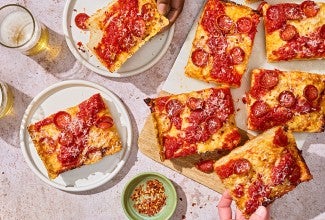 Slices of Weeknight Detroit Pizza on a table, shown from above.