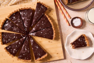 Candy Bar Pecan Tart seen from above - sliced on a cutting board
