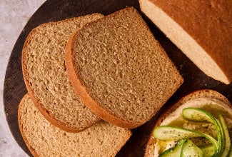 Classic 100% Whole Wheat Bread sliced on a cutting board