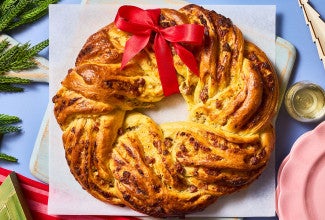 Italian Herb & Cheese Wreath on a cutting board seen from above.