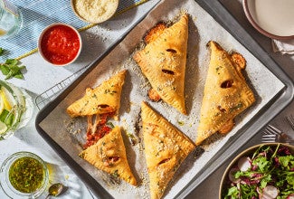 Flaky Puff Crust Pizza Turnovers on a baking sheet