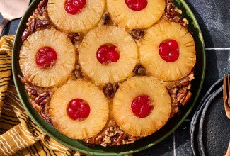 Pineapple Upside Down Cake seen from above with caremelized pineapple rings filled with maraschino cherries