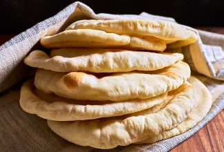 A stack of Golden Pita Bread on a counter