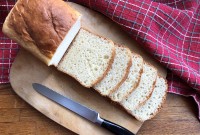 Sliced sandwich loaf on cutting board