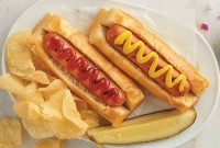 Hot dogs with chips and a pickle