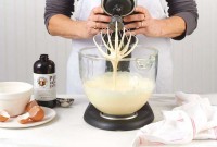 Stand mixer with batter trailing from whisk 