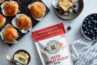 Bag of keto wheat flour next to muffins