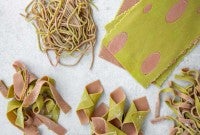 Different shapes of two-toned green and pink pasta