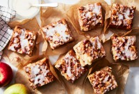 Slices of apple fritter cake on a sheet of parchment 