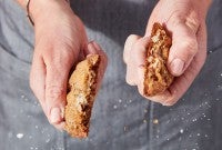 A Salty-Sweet Butter Pecan Cookie being snapped in half.