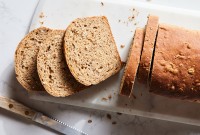 A loaf of malted wheat bread cut into slices