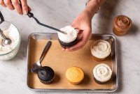 Mini offset spatula being used to frost a cupcake