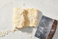 Biscuit dough being folded like a letter