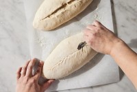 Baker scoring bread dough