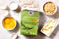 Open bag of Climate Blend flour next to various baking ingredients