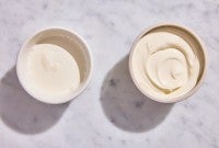 A bowl of leftover heavy cream next to a bowl of creme fraiche