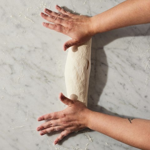 French Bread dough being rolled out - select to zoom