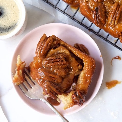Sticky bun on a plate with a cup of coffee - select to zoom