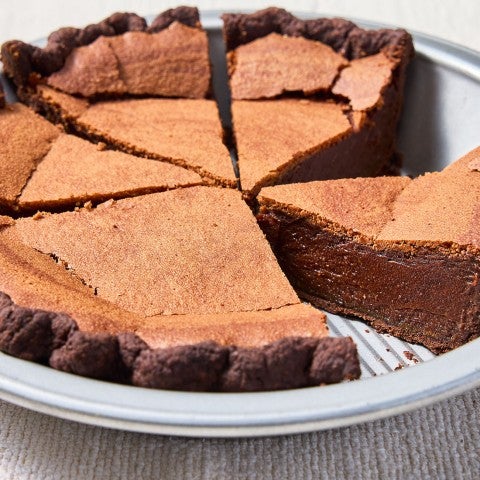 Chocolate Chess Pie sliced inside a pie tin seen from the side. - select to zoom