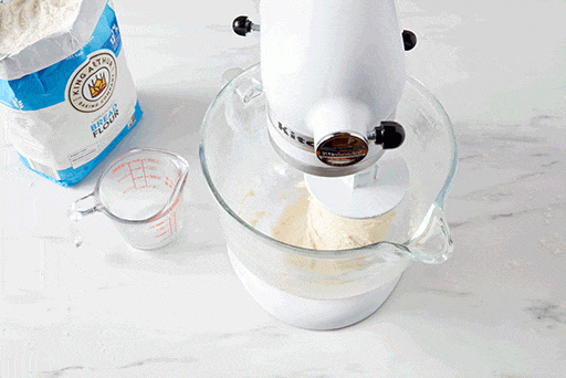 A top-down shot into the bowl of a stand mixer, showing that the dough should be smooth, elastic, and tacky. 