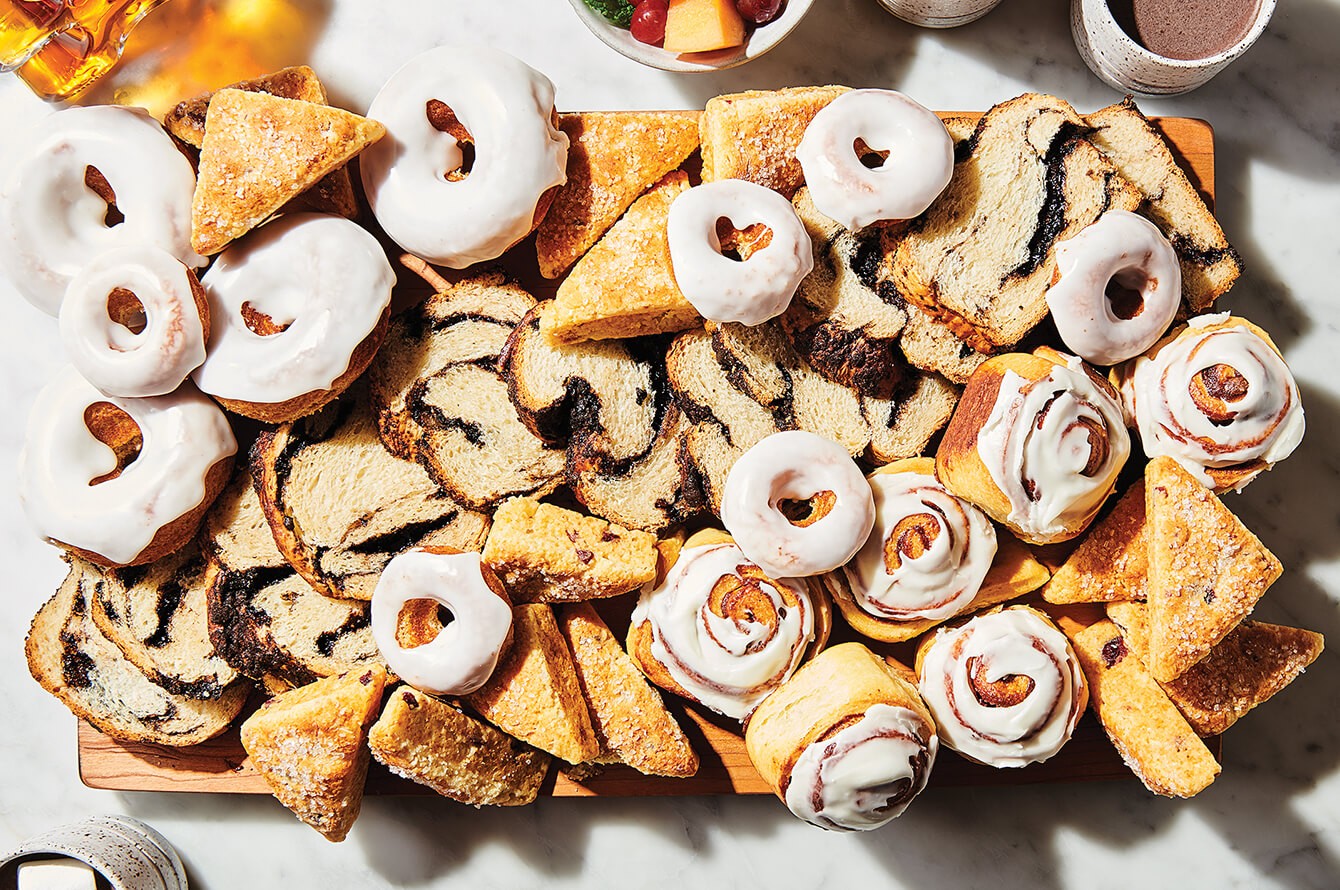 A tray of scones, doughnuts, sweet rolls, and babka slices