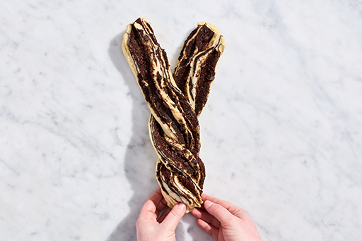 Chocolate Sourdough Babka dough being twisted together to make a dough rope.