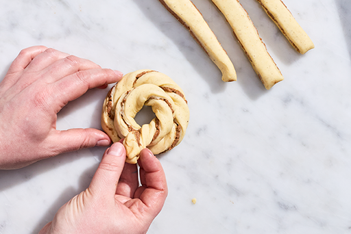 Sun Bun dough strips being formed into a circle.