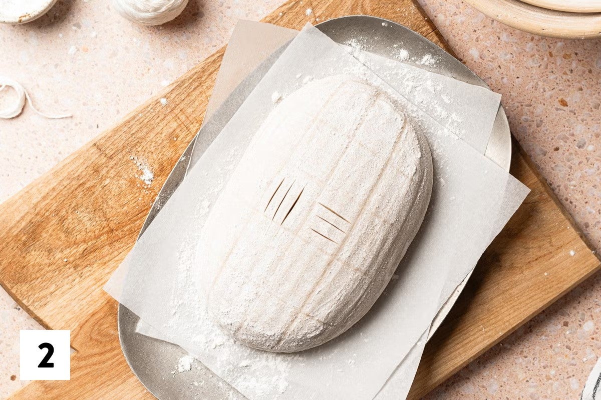 Sourdough loaf with the start of a basket weave design scored into it
