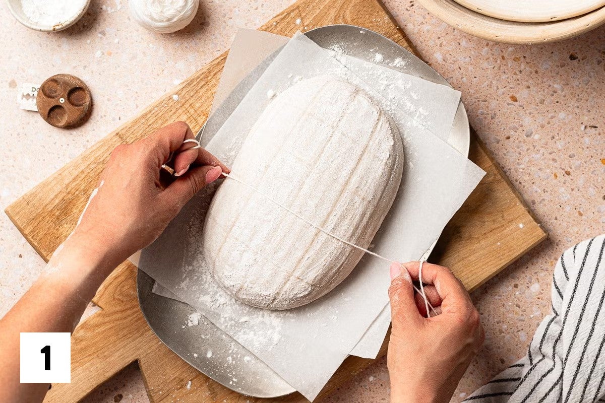 Using butcher's twine to divide a loaf of bread dough into square grids