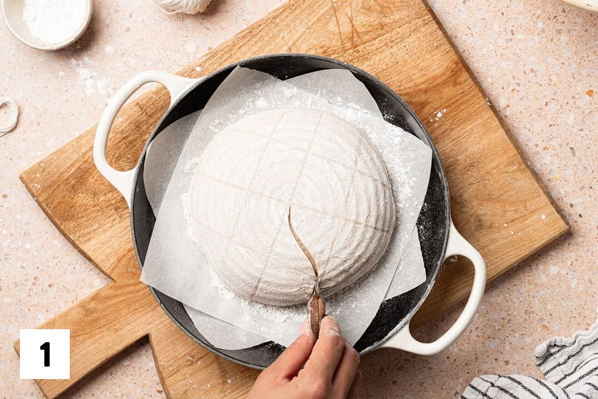Scoring an S pattern into a gridded sourdough loaf