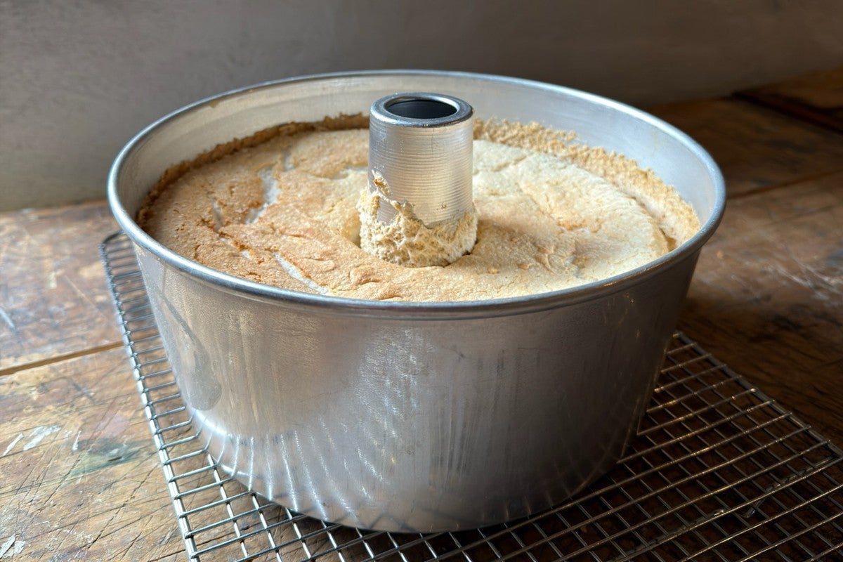 Angel food cake cooled right-side up, still in its pan 