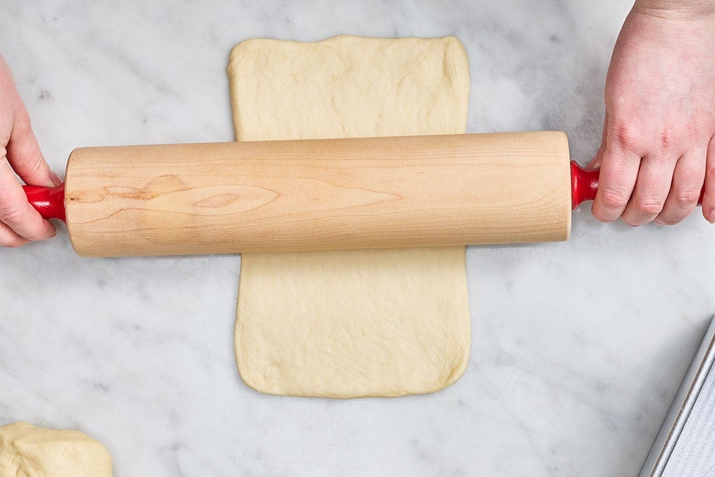 Using a rolling pin to flatten out Sourdough Milk Bread dough