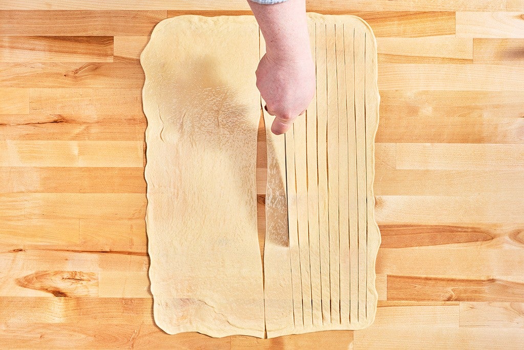 Slicing Thousand Layer Mo dough.