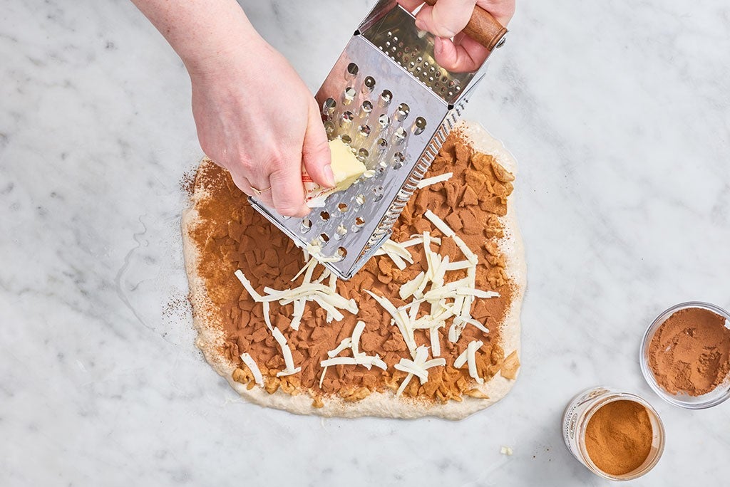 Grating cold butter into Apple Cinnamon Sourdough Bread dough