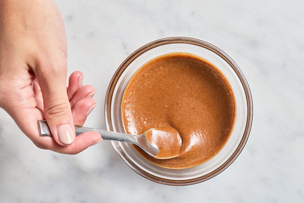 Copper colored brown butter mixed with milk powder after cooking