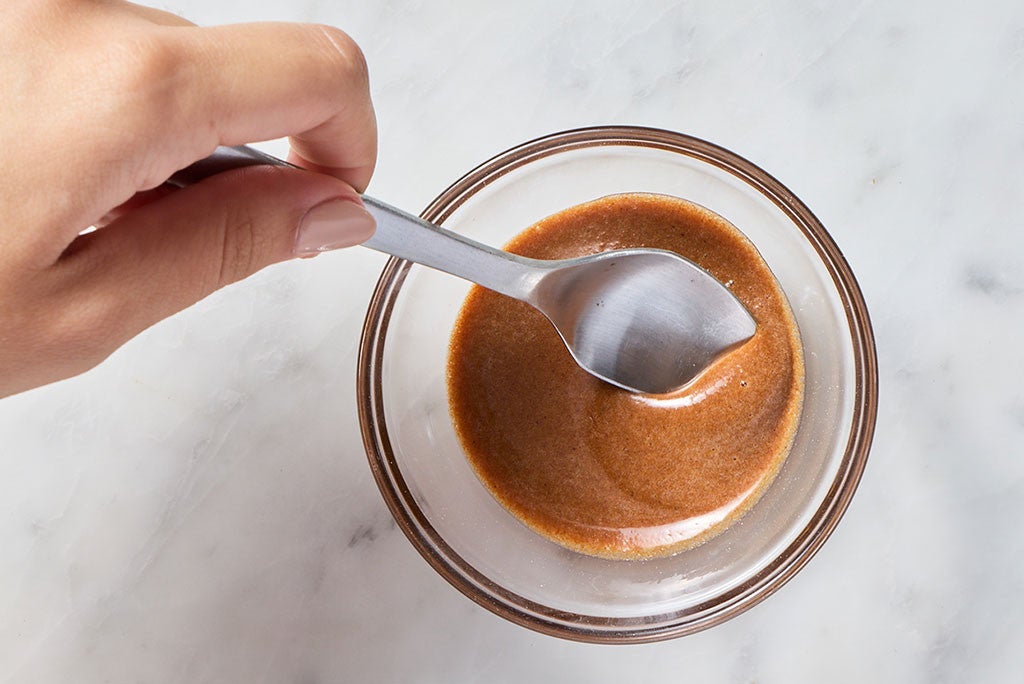 A spoon in a bowl of brown butter