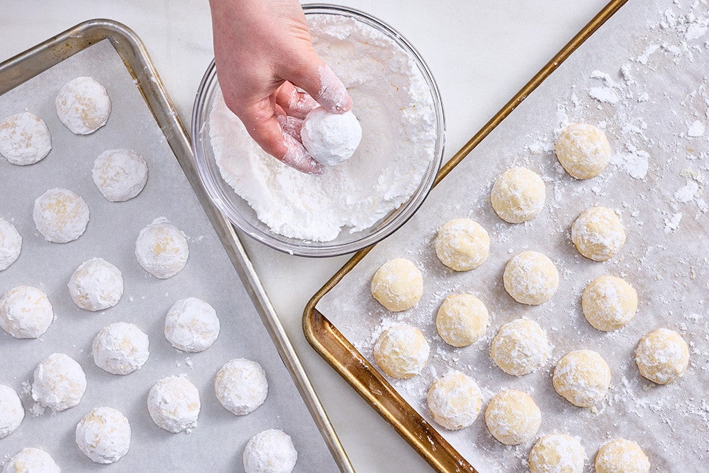 Dusting Lemon Snowball Cookies with powdered sugar