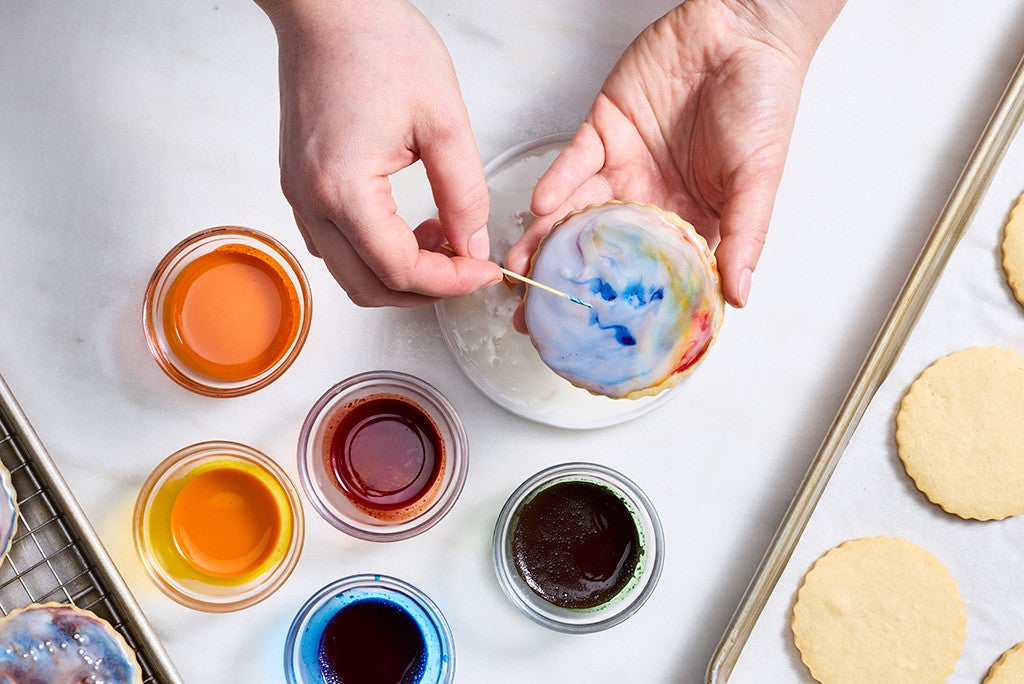 Adding drops of color to an iced cookie