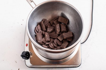 Chocolate wafers in a bowl of a double boiler about to be melted