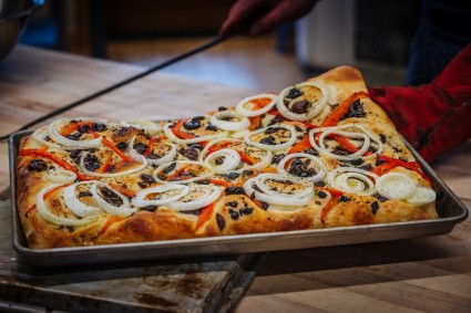 Focaccia on a sheet pan from a wood-fired oven