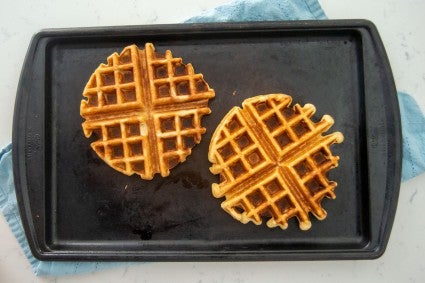 Gluten-free waffle next to all-purpose flour waffle on baking sheet