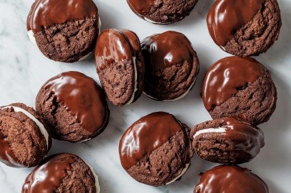 Chocolate and peppermint sandwich cookies that have been partially dipped into tempered chocolate