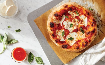 Baked Neapolitan-style pizza on a parchment-lined baking steel