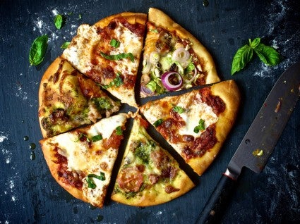 Slices of pizza with different toppings assembled together in a circle