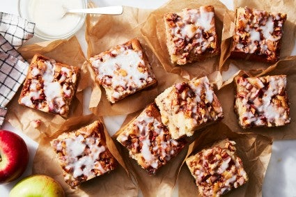 Slices of apple fritter cake on a sheet of parchment 